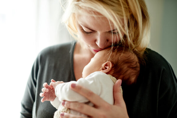 Shot of a mother spending time with her newborn baby